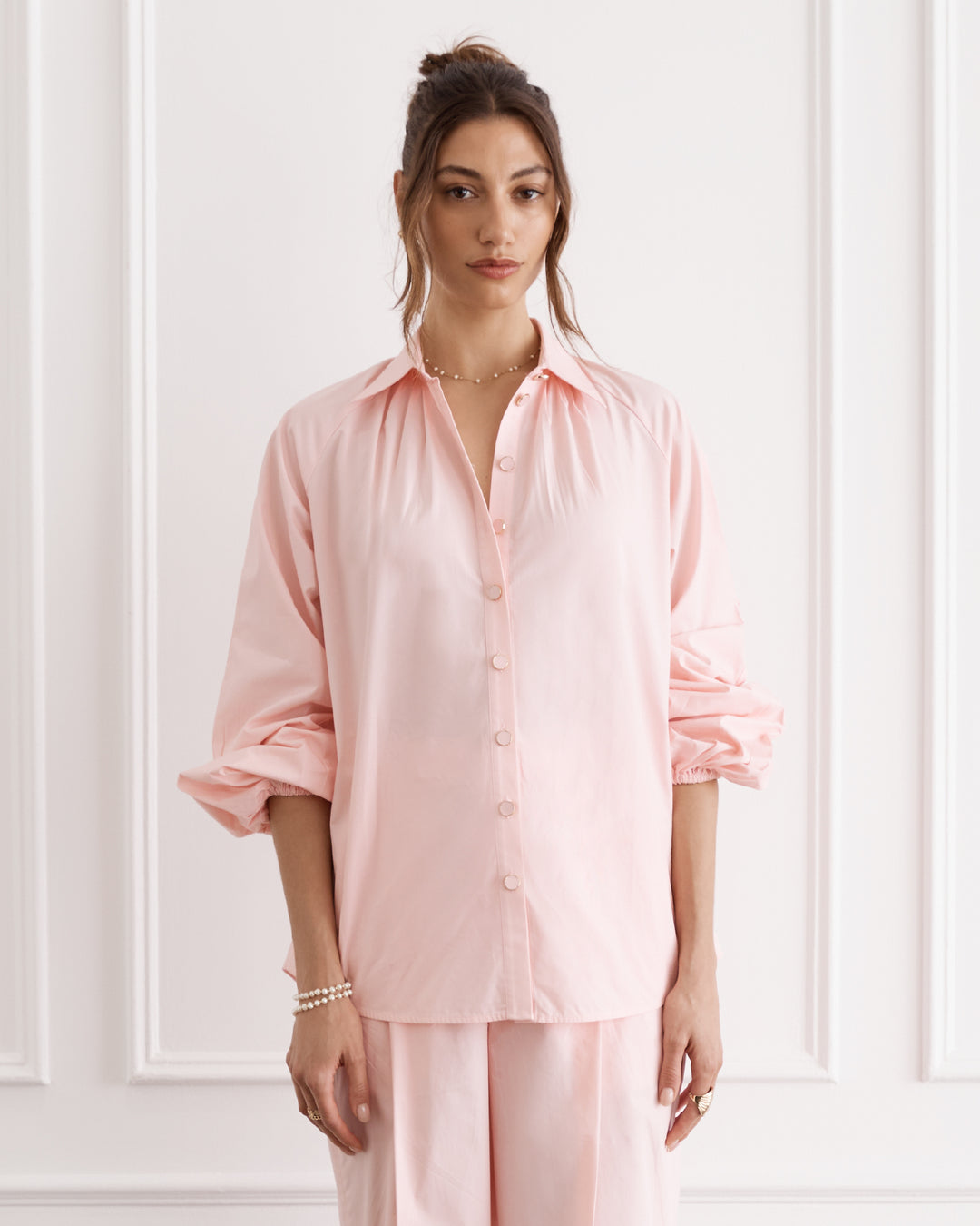 Pink blouse with long sleeves and collar with button down front